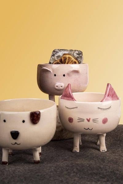 pot with a smiling cat figure. cat's ears are in pink colour.