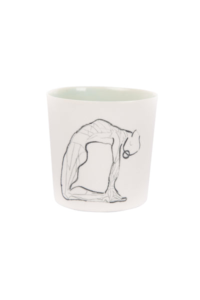 white coloured outside, light green coloured inside Camel yoga pose drawn mug