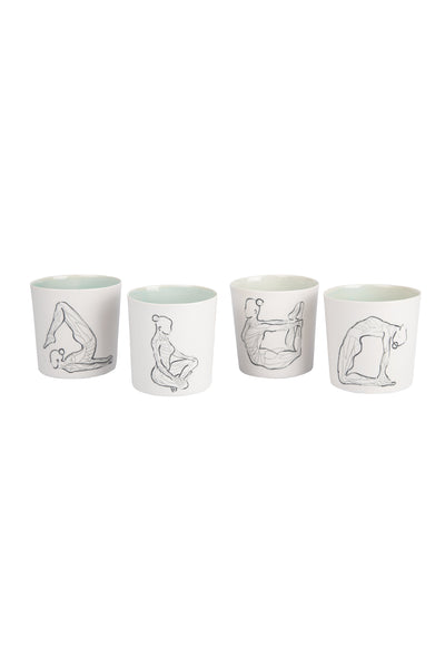 group of white coloured outside, light green coloured inside yoga pose drawn mug light green