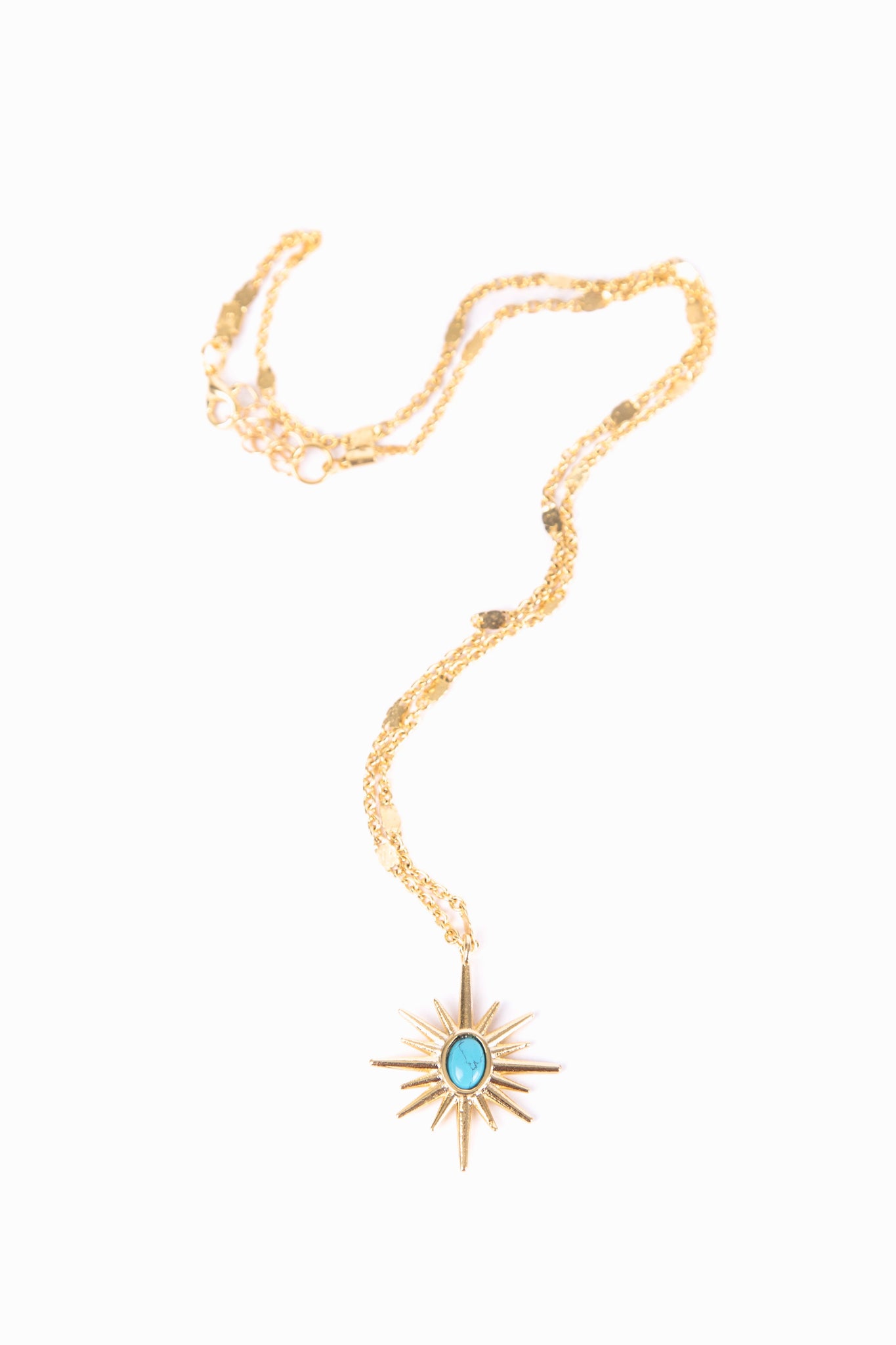 gold necklace with sun figure which has blue stone in it