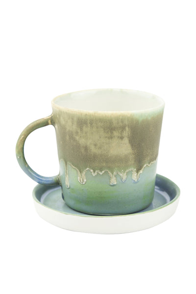 green and turquoise coloured cup with its plate