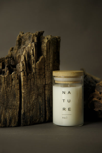 candle in glass jar with wooden lid with wood