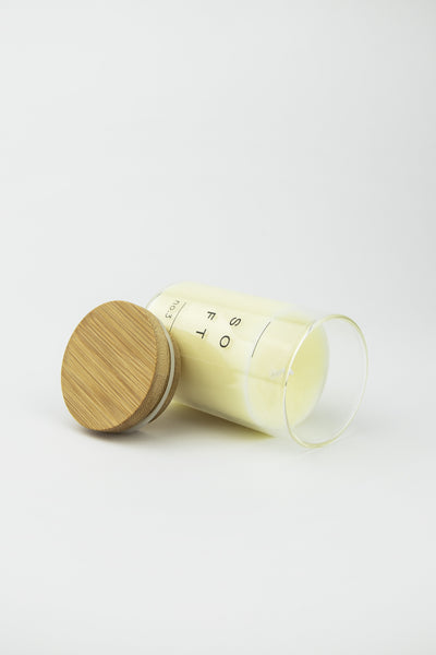 candle in glass jar with wooden lid open