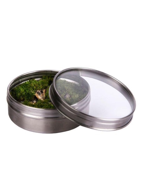 terrarium magnet with stones in it. terrarium placed in circle shaped metal magnet jar and glass lid open