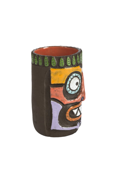 colourful tiki beer mug. tiki face has two big circle eyes, triangle shaped seven teeth, big orange coloured nose side